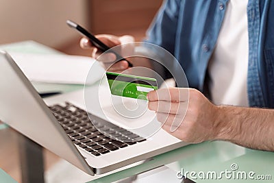 Young man making online purchase on mobile phone Stock Photo