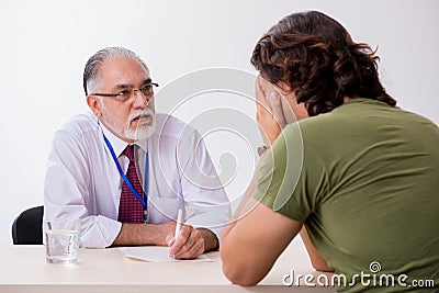 Young man meeting with advocate in pre-trial detention Stock Photo