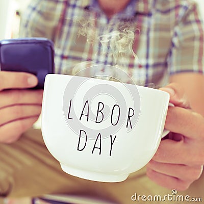 Young man with a mug with the text labor day Stock Photo