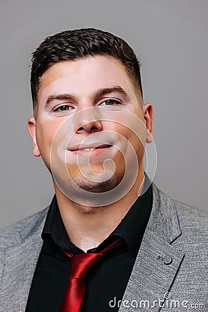 A young man with a non standard weight looking at camera is quite pleased with himself. Stock Photo