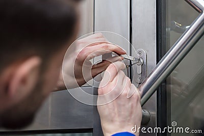 Young Man Opening Door Stock Photo