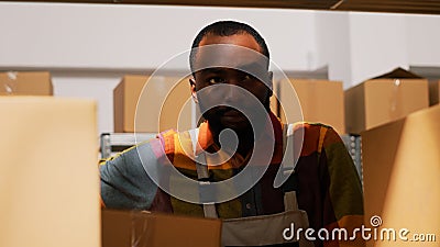 Young man organizing boxes in depot Stock Photo