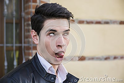 Young man outdoor doing silly face and stupid Stock Photo