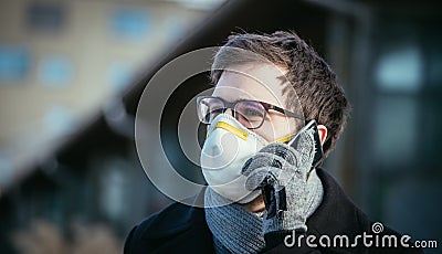Flue and corona safety concept. Man wearing face mask to protect himself, outdoors Stock Photo