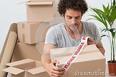 Young Man Packing Cardboard Box Stock Photo