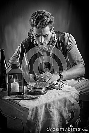 Young Man in Pirate Fashion Outfit Looking at Gold Stock Photo