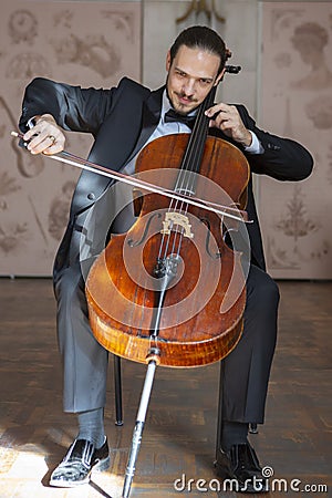 Young man playing the cello. Portrait of the cellist Stock Photo