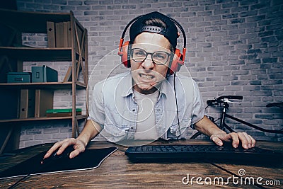 Young man playing game at home and streaming playthrough or walk Stock Photo