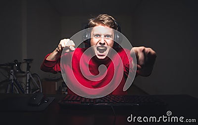 Young man playing game at home and streaming playthrough or walkthrough video Stock Photo