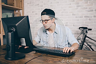 Young man playing game at home and streaming playthrough or walkthrough video Stock Photo