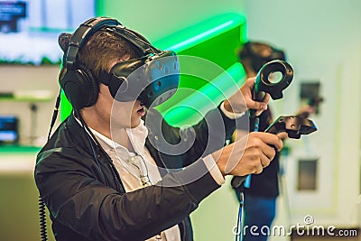 Young man playing video games virtual reality glasses. Cheerful Stock Photo