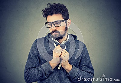 Young man pointing feeling shy and guilty in awkward situation Stock Photo