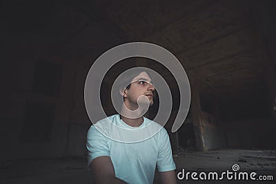 Young man posing in abandoned room Stock Photo