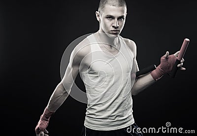 Young man posing with nunchaku Stock Photo