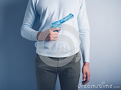 Young man posing with water pistol Stock Photo