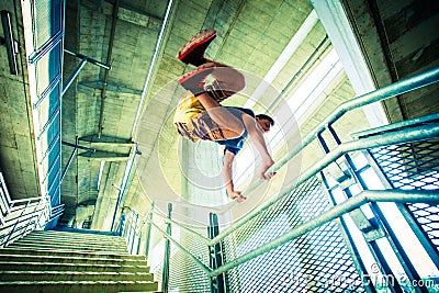 Young man practice parkour jump in the city Stock Photo