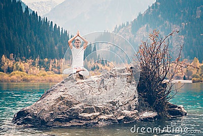 A young man practices yoga. Exercise Agni Stambhasana Stock Photo