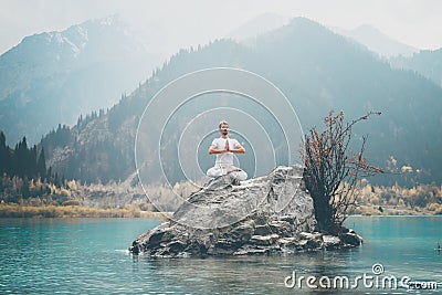 A young man practices yoga. Exercise Agni Stambhasana Stock Photo