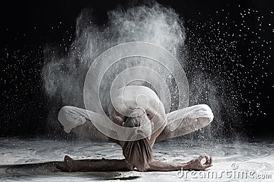 Young man practicing yoga, sitting in Garland exercise with forward bend, variation of Malasana pose Stock Photo