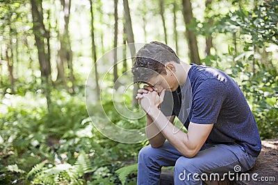 Young man in prayer Stock Photo