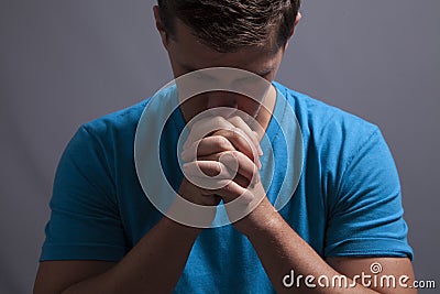 Young Man Prays Stock Photo