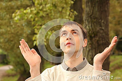 Young man prays outdoor in summer Stock Photo