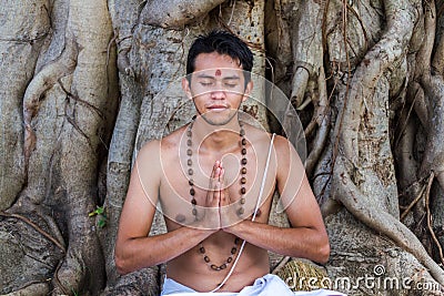 Young man prays Stock Photo