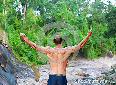 The young man prays to god and enjoys beauty of the nature Stock Photo