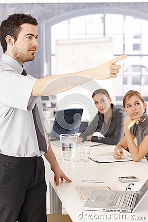 Young man presenting in meeting room Stock Photo