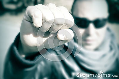 Young man in a protest raising his fist, with a filter effect Stock Photo