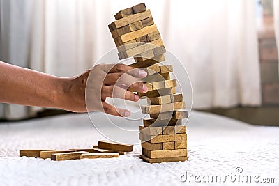 Young man pulling out wood block fail Stock Photo