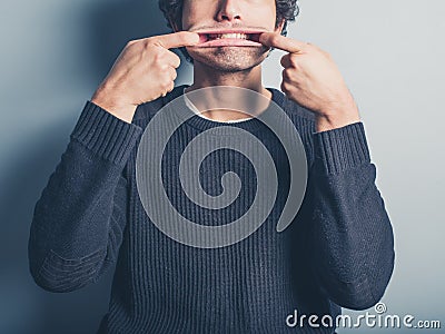 Young man pulling silly faces Stock Photo