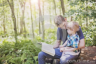 Young man reading bible to child Stock Photo