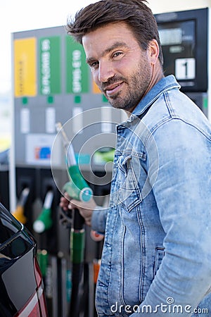young man refuelling car at petrol station Stock Photo