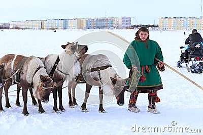 The young man the reindeer breeder with reindeers Editorial Stock Photo