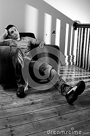 Young man relaxing on a chair Stock Photo