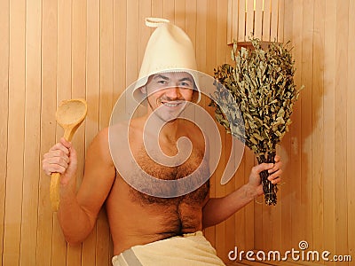 Young man relaxing in a russian wooden sauna Stock Photo