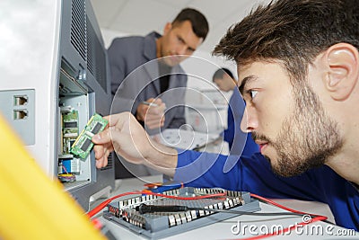 Young man repairer working in service center Stock Photo