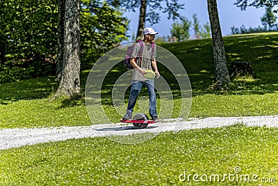 The young man rides on Onewheel Editorial Stock Photo
