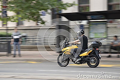Young man riding a motorbike on city street Editorial Stock Photo