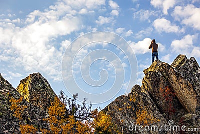 Young man on the rock of Raspberry Mountain Editorial Stock Photo