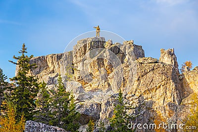 Young man on the rock of Raspberry Mountain Editorial Stock Photo