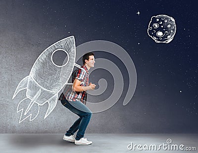 Young man with a rocket on his back Stock Photo