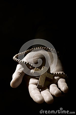 Young man with a rosary in his hand Stock Photo