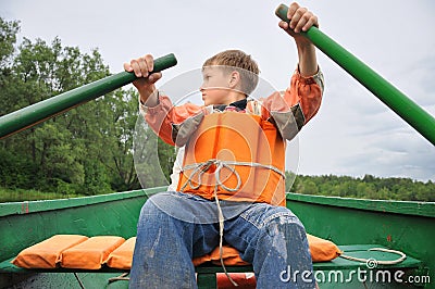 Young man rowing a boat Stock Photo