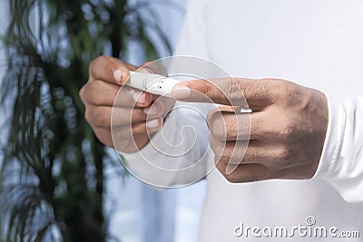 Young man`s hand measure glucose level at home Stock Photo