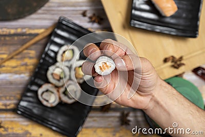 young man's hand ready to gobble down a piece Stock Photo