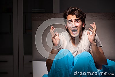 The young man scared in his bed having nightmares Stock Photo