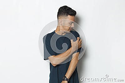 Young man scratching arm allergy itchy skin isolated on white background Stock Photo