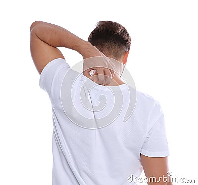 Young man scratching back on white background. Stock Photo